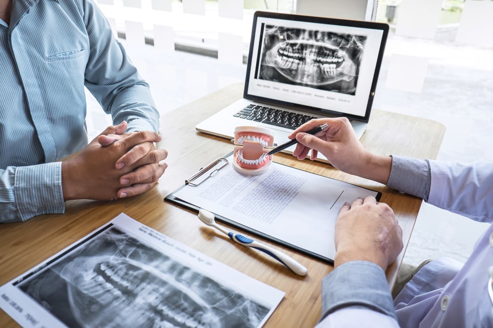  Dentist Consulting with Patient 